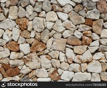 Seamless rough medieval stone wall background.