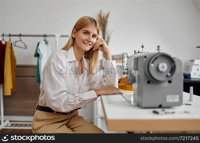 Seamstress works on sewing machine at her workplace in workshop. Dressmaking occupation, handmade tailoring business, handicraft hobby. Seamstress works on sewing machine at workplace