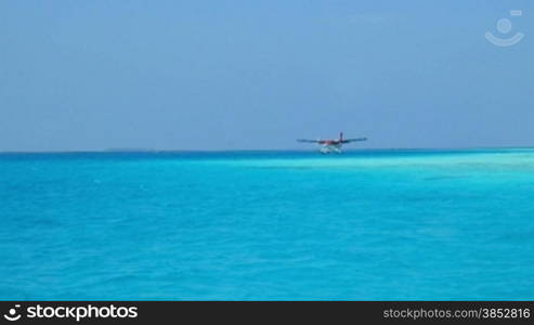 Seaplane makes landing on water. Maldives Indian Ocean.
