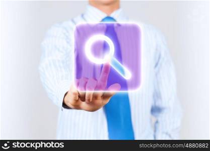 Search icon. Close up of businessman touching search icon