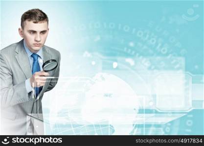 Searching and examining. Image of businessman examining objects with magnifier