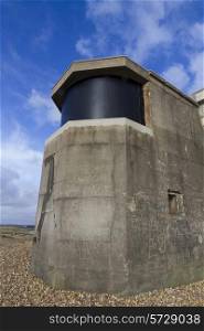 Searchlight emplacement from the second world war, with modern screen over emplacement.