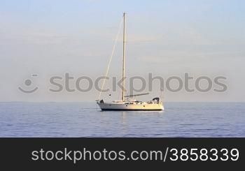 Seascape, a yacht anchored, rippling water surface, swimmer in a distance