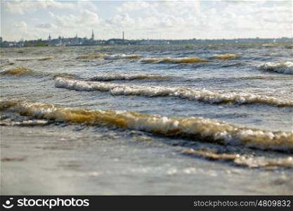 seascape and landscape concept - baltic sea waves and talling city outlines. baltic sea waves and tallinn city outlines