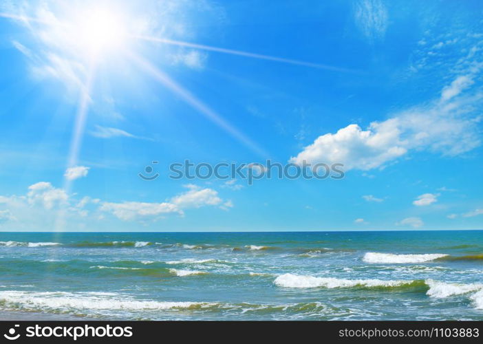 Seascape and sun on blue sky background.