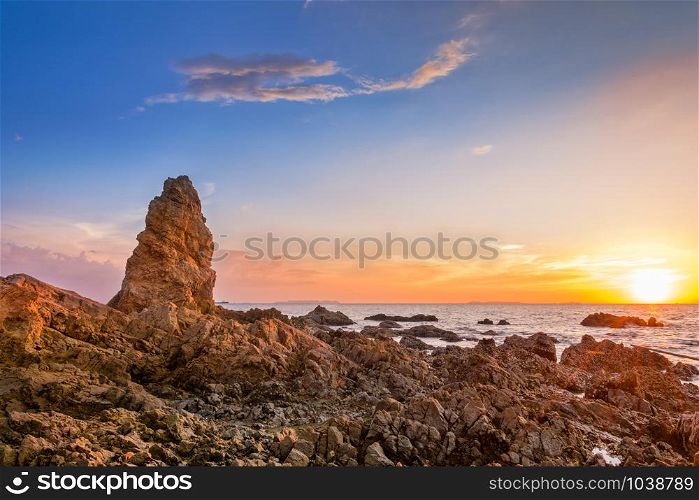 Seascape at the sea with stone during sunset