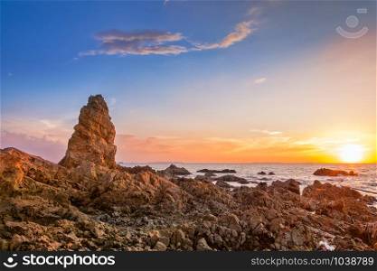Seascape at the sea with stone during sunset
