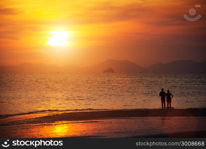 Seascape, beautiful sunset beach with silhouette couples together at Krabi, Thailand.