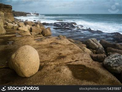 Seascape landscape of waves crashing onto rocks during beautiful Winter&rsquo;s day