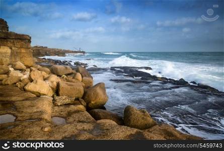 Seascape landscape of waves crashing onto rocks during beautiful Winter&rsquo;s day
