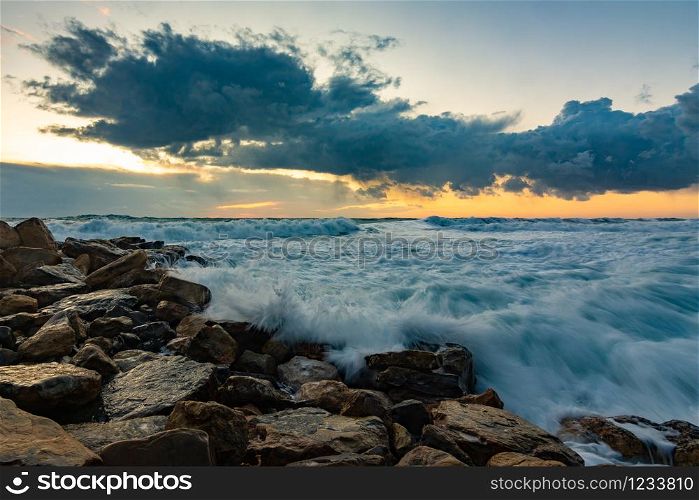 Seascape on rocky shore in storm