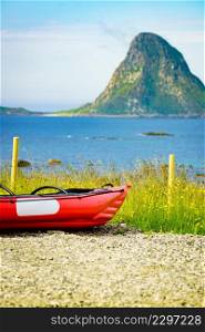 Seascape, sea coast with red canoe kayak on shore, resort Bleik Andoya Norway. Vesteralen archipelago.. Sea coast with red canoe on shore Andoya Norway