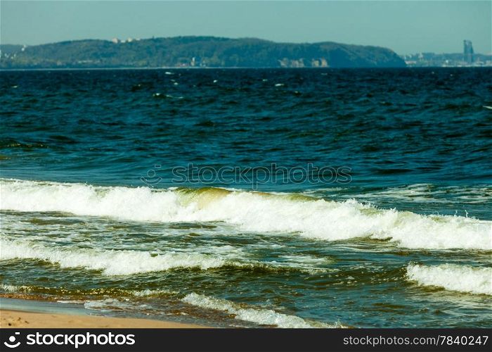 Seascape. Sea waves on the shore of the sandy beach. Summer vacation in the resort.
