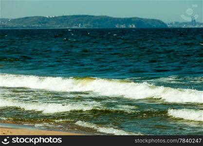 Seascape. Sea waves on the shore of the sandy beach. Summer vacation in the resort.