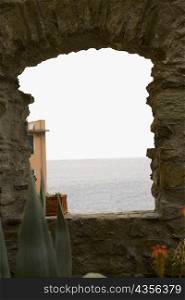 Seascape view through a window, Cinque Terre National Park, La Spezia, Liguria, Italy