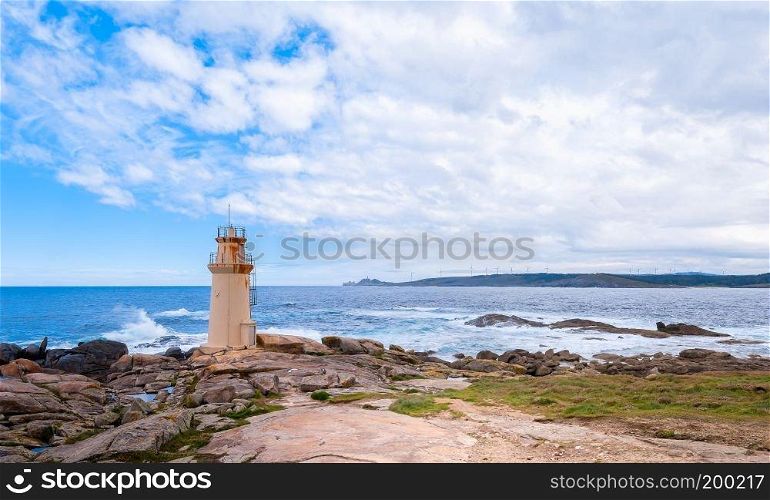 Seascape with cliff and lighthouse. Muxia Spain.