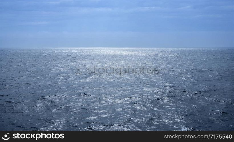 seascape with reflection of sunlight on the water and blue sky