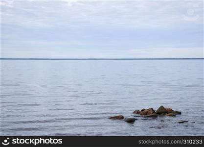 Seascape witth stones in a calm water by the coast of the swedish island Oland in the Baltic Sea