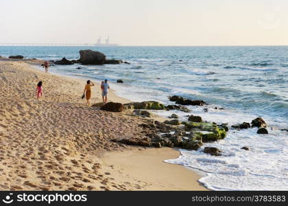 Seaside at sunset and walking along the beach.