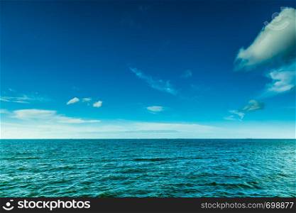 Seaside landscapes, travel adventure concept. Blue ocean and sunny sky with clouds.. Blue ocean and sunny sky with clouds