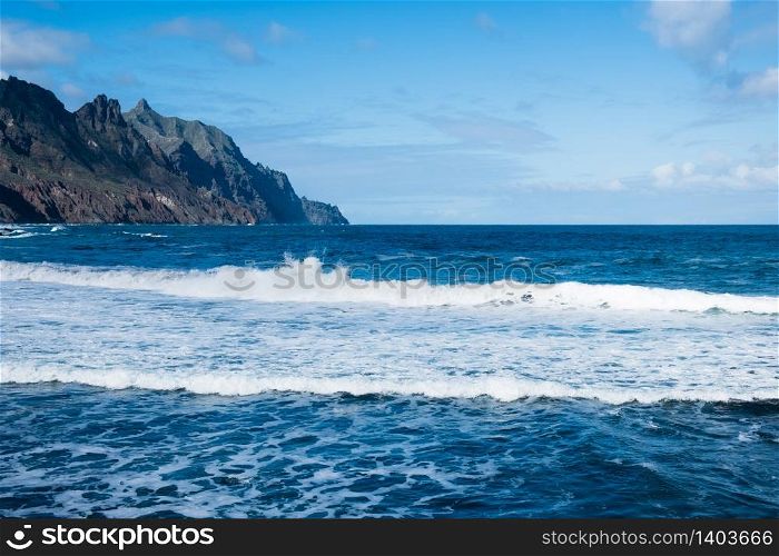 Seaside resort on Tenerife island. Ocean on a summer day, waves. Tourism and travel, vacation. Panoramic landscape.