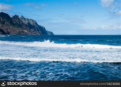 Seaside resort on Tenerife island. Ocean on a summer day, waves. Tourism and travel, vacation. Panoramic landscape.