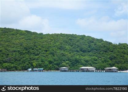 Seaside resort. On the island. A tree covered mountains and crystal clear waters and clear skies.