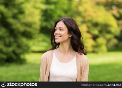 season and people concept - beautiful happy young woman in summer park. beautiful happy young woman in summer park