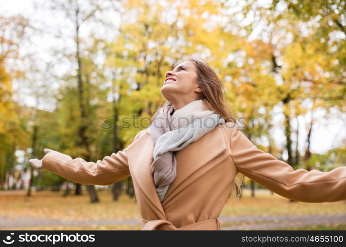 season and people concept - beautiful happy young woman walking in autumn park. beautiful happy young woman walking in autumn park