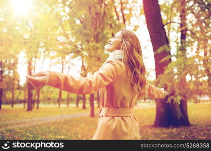 season and people concept - beautiful happy young woman walking in autumn park. beautiful happy young woman walking in autumn park