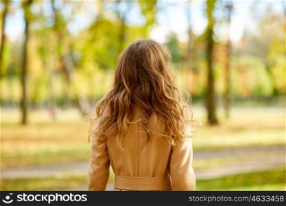 season and people concept - beautiful young woman walking in autumn park. beautiful young woman walking in autumn park