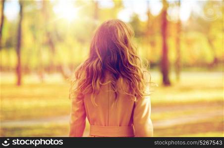 season and people concept - beautiful young woman walking in autumn park. beautiful young woman walking in autumn park