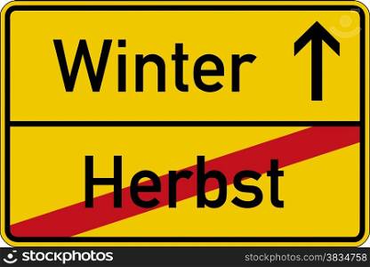Season change. The German words for autumn and winter (Herbst and Winter) on a road sign