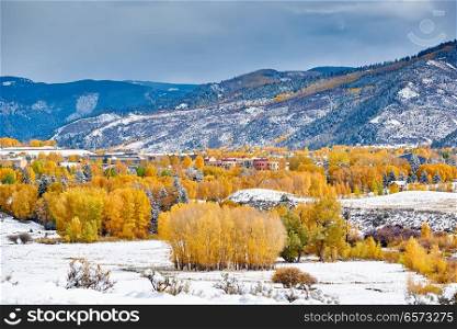 Season changing, first snow and autumn trees. Rocky Mountains, Colorado, USA. 