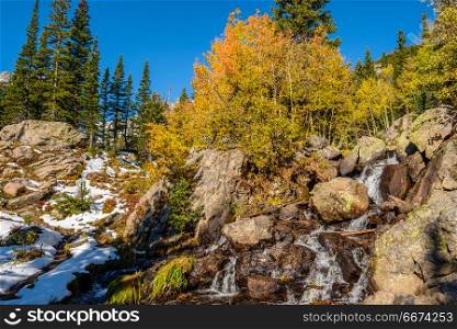 Season changing, first snow and autumn trees. Season changing, first snow and autumn aspen trees in Rocky Mountain National Park, Colorado, USA.