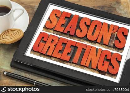 season greetings typography - text in letterpress wood type on a digital tablet