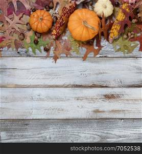 Seasonal fall decorations in top border on rustic white wooden boards