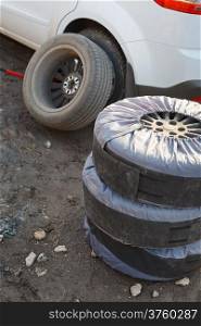 seasonal replacement of tires with jack outdoors - choice of wheel