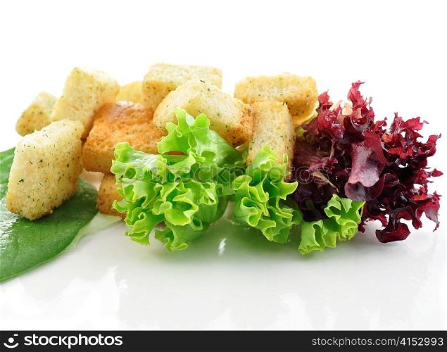 seasoned croutons and salad leaves , close up