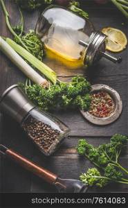 Seasoning and meals flavor concept for cooking vegetarian food. Parsley, pepper mill and oil on a rustic wooden table, close up. Home cuisine