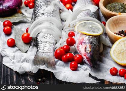 Seasoning for raw fish. Carcass raw fish on the kitchen table with spices