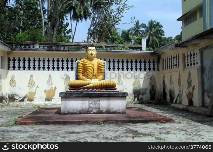 Seated Buddha near wall in Wewurukannala Vihara near Dikwella, Sri Lanka