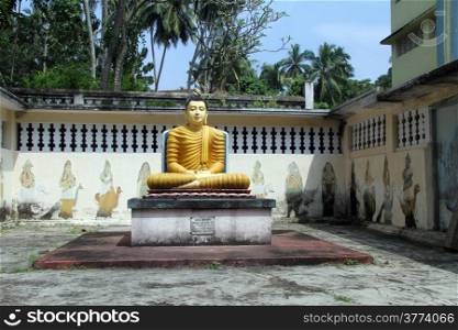 Seated Buddha near wall in Wewurukannala Vihara near Dikwella, Sri Lanka