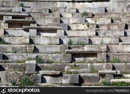 Seats and grass in the theater in Priene, Turkey