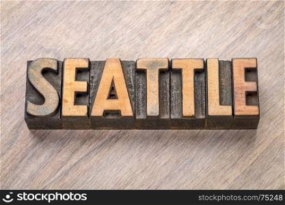 Seattle word abstract in vintage letterpress wood type against grained wooden background
