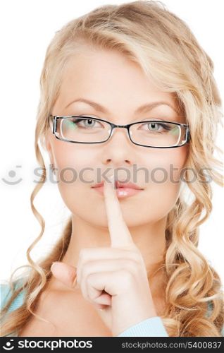 secret and vision concepts - woman wearing eyeglasses with finger on her lips