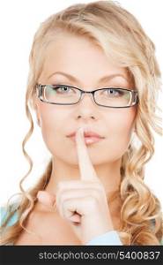 secret and vision concepts - woman wearing eyeglasses with finger on her lips