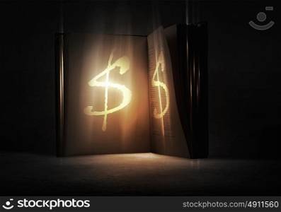 Secret of financial success. Old opened magic book with dollar symbol