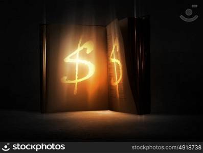 Secret of financial success. Old opened magic book with dollar symbol
