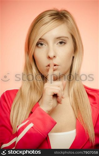 Secret woman finger on lips. Teen sporty girl showing hand silence sign, saying hush be quiet.